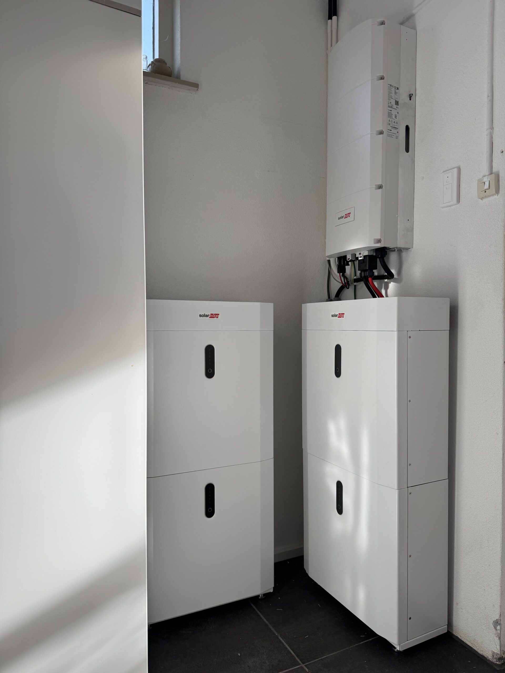 Twee SolarEdge thuisbatterijen met omvormer in een bijkeuken